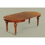 A Victorian mahogany extending dining table of moulded circular form,