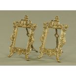A pair of moulded brass easel back photograph frames. Height 28 cm, width 18 cm.