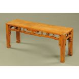 A Chinese stained wooden rectangular stool, with half round spindle mouldings to the pierced frieze.