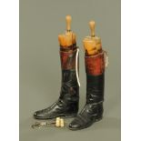 A pair of vintage leather riding boots, with wooden trees and with boot pulls.