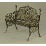 A cast iron garden bench, with cameo back and slatted seat and raised on front sabre type legs.