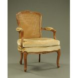 An early 20th century French armchair, with bergere back,