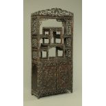 A 19th century Chinese hardwood cabinet in two sections,