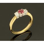 An 18 ct yellow gold ruby and diamond three stone ring, ruby +/- 0.48 carats.