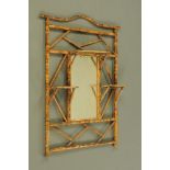 A bamboo framed and lacquered overmantle mirror with three shelves. Height 108 cm, width 88 cm.
