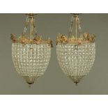 A pair of metal and glass bag form chandeliers, overall height 64 cm, diameter 32 cm.