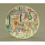 A 19th century Chinese plate, decorated in Canton colours with boys. Diameter 29.5 cm.