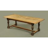 A large oak refectory table, with three centre planks with framed surround,