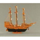 A model galleon, hand built, timber with rigging, last quarter 20th century. Length 79 cm.