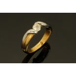 An 18 ct two tone gold twist ring, semi-tension set with a diamond weighing +/- 0.36 ct. Size P.