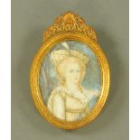 A portrait miniature signed Leiret, depicting a young girl with Indian style headdress. 9 cm x 6.