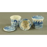 A pair of blue and white cylindrical lidded soap dishes, each with detachable drainer.
