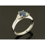 A platinum sapphire and diamond cluster ring, sapphire +/- 0.90 carats, diamonds +/- 0.72 carats.