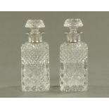 A pair of silver mounted cut glass square form decanters, each with stopper, London hallmark 1957.