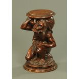 A 19th century carved softwood plant stand, in the form of a kneeling male figure.