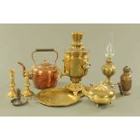 An antique brass oil lamp, a copper kettle, a pair of brass candlesticks, small oil lamp,