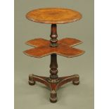 A Victorian circular wine table, with shaped revolving shelf with turned columns and triform base.