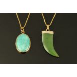 Two 9 ct gold pendants, one in the form of a green jade "claw" and another oval.
