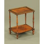 A small Victorian rosewood two tier whatnot stand, with turned supports and short turned legs.