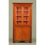 A George III mahogany standing corner cabinet,