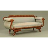 An Empire style mahogany framed settee, with exposed show frame,