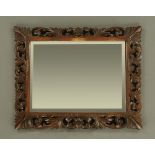 A large early 20th century continental oak framed mirror,