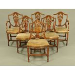 A set of six mahogany shield back dining chairs, two carver arm and four single,
