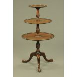 A George III mahogany circular three tier dumb waiter.