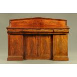 A Victorian mahogany sideboard, with rear triangular upstand,