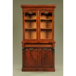 A Victorian mahogany bookcase on cupboard,