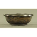 A Chinese bronze dish, decorated with dragons and with character mark to base. Length 15 cm.