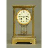 A late Victorian brass four glass library clock,