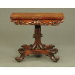 A Victorian mahogany turnover top tea table, with shaped column, quatreform base and scroll feet.