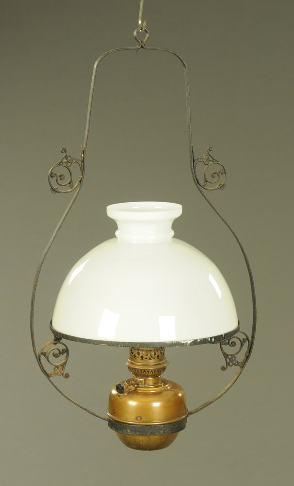 A 19th century hanging oil lamp with glass shade. Height +/- 80 cm, frame width +/- 44 cm.