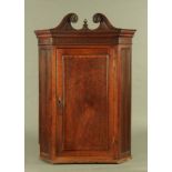 A George III mahogany corner cupboard,