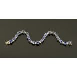 An 18 ct gold tanzanite and diamond set tennis bracelet, diamonds +/- 1.