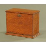 A Victorian oak stationery box, rectangular with hinged lid and slope front. Width 29.5 cm.