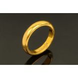 A 22 ct gold wedding band, Size L. 6.3 grams.