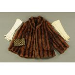 A ladies vintage fur coat, together with an Art Deco evening bag and pair of gloves.