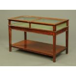 An Edwardian mahogany and glass topped display case,