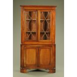 A George III mahogany standing corner cupboard,