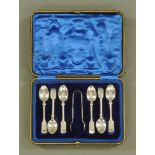 A cased set of six silver fiddle pattern coffee spoons, with sugar tongs,
