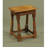 An 18th century oak joint stool, with moulded edge and angled supports with low stretchers.