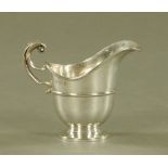 A silver helmet shaped cream jug, Birmingham mark 1907, 83 grams.