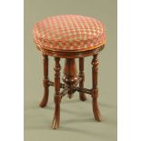 A Victorian mahogany piano stool, with rise and fall action,