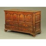 A George III oak four panelled mule chest, with lift up top,