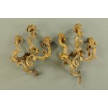 A pair of 19th century gilt gesso three branch wall sconces, of leaf scroll rococo design.