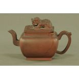 A Chinese Yixing teapot, with dog terminal. Height 14 cm, length 22 cm.