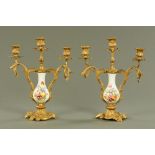 A pair of Continental porcelain and gilt metal mounted three branch candelabra, circa 1900,