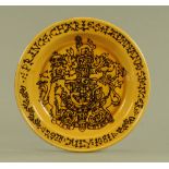 A large Wetheriggs mustard glazed and black slip decorated Commemorative charger,